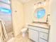 Bathroom featuring a shower, vanity, toilet, and decorative lighting at 16204 3Rd E St, Redington Beach, FL 33708