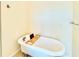 Clawfoot bathtub with stylish hardware and a convenient wooden bath caddy at 16204 3Rd E St, Redington Beach, FL 33708
