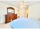 Bedroom boasts a dresser, ceiling fan, and neutral color scheme at 16204 3Rd E St, Redington Beach, FL 33708