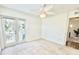 Bright bedroom with a ceiling fan and access to a private balcony at 16204 3Rd E St, Redington Beach, FL 33708