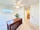 Bedroom featuring a ceiling fan, carpet, and a view into the bathroom at 16204 3Rd E St, Redington Beach, FL 33708