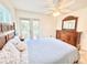 Inviting bedroom with a comfortable bed, dresser, and access to a balcony at 16204 3Rd E St, Redington Beach, FL 33708