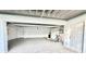 Spacious two-car garage with white walls, epoxy floors, and extra storage space at 16204 3Rd E St, Redington Beach, FL 33708