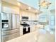 Modern kitchen featuring stainless steel appliances, custom cabinets, and tiled backsplash at 16204 3Rd E St, Redington Beach, FL 33708