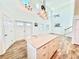 Open floor plan combining kitchen and living room with staircase to second floor at 16204 3Rd E St, Redington Beach, FL 33708