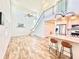 Open floor plan with kitchen, living room, and staircase to upper floor at 16204 3Rd E St, Redington Beach, FL 33708