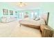 Bright, expansive main bedroom with ample space for seating area, balcony access and walk-in closet at 16204 3Rd E St, Redington Beach, FL 33708