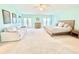 Bright, expansive main bedroom with ample space for seating area, balcony access and walk-in closet at 16204 3Rd E St, Redington Beach, FL 33708