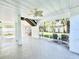 Screened in porch, featuring outdoor seating, ceiling fan and view of backyard at 16204 3Rd E St, Redington Beach, FL 33708