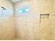 Modern tiled shower with accent tile and a built-in niche at 16204 3Rd E St, Redington Beach, FL 33708