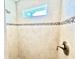 Beautiful shower features modern fixtures, decorative tile, and a charming window at 16204 3Rd E St, Redington Beach, FL 33708