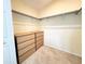 Spacious walk-in closet featuring dual hanging rods, shelving and built-in storage drawers at 16204 3Rd E St, Redington Beach, FL 33708