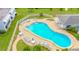 Aerial view of a community pool with chairs and tables at 1655 S Highland Ave # F126, Clearwater, FL 33756