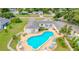 Aerial view showcasing community pool, green spaces, and residential buildings at 1655 S Highland Ave # F126, Clearwater, FL 33756