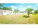Backyard view showcasing a well-maintained lawn, pool, and white picket fence at 1655 S Highland Ave # F126, Clearwater, FL 33756