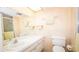 Bright bathroom features a spacious vanity, mirror, and a separate shower area at 1655 S Highland Ave # F126, Clearwater, FL 33756