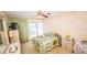 Relaxing bedroom includes a comfortable bed, dresser, and a ceiling fan at 1655 S Highland Ave # F126, Clearwater, FL 33756