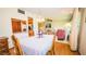Dining room featuring a chandelier, hardwood floors, and seamless access to the cozy living room at 1655 S Highland Ave # F126, Clearwater, FL 33756