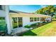 Exterior of the home with well-maintained lawn and access through sliding glass doors at 1655 S Highland Ave # F126, Clearwater, FL 33756
