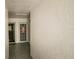 Inviting hallway with textured walls and a view of the entrance door adorned with Easter decor at 1655 S Highland Ave # F126, Clearwater, FL 33756