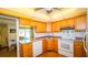 Cozy kitchen with wooden cabinets, hardwood floors, and seamless access to the dining area at 1655 S Highland Ave # F126, Clearwater, FL 33756