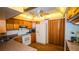Well-lit kitchen featuring wooden cabinets, a ceiling fan, and modern appliances for cooking at 1655 S Highland Ave # F126, Clearwater, FL 33756