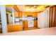 Cozy kitchen featuring wooden cabinets, modern appliances, and a clean white refrigerator at 1655 S Highland Ave # F126, Clearwater, FL 33756