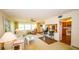 Bright living room featuring a ceiling fan, large windows, and an open view to the dining area at 1655 S Highland Ave # F126, Clearwater, FL 33756