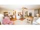Comfortable living room with ample seating, including a plush armchair and open access to other rooms at 1655 S Highland Ave # F126, Clearwater, FL 33756