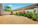 Rear patio provides a private outdoor space with lush tropical landscaping and gravel surface at 1655 S Highland Ave # F126, Clearwater, FL 33756