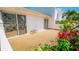 Outdoor patio featuring a gravel surface, decorative doors, and colorful tropical foliage at 1655 S Highland Ave # F126, Clearwater, FL 33756