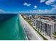 Breathtaking aerial view of the pristine coastline, showcasing luxury condos and the sparkling turquoise waters at 1660 Gulf Blvd # Ph-7, Clearwater Beach, FL 33767