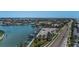 Aerial view showcasing waterfront homes and a marina along the coast at 1660 Gulf Blvd # Ph-7, Clearwater Beach, FL 33767