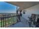 Corner condo balcony providing panoramic waterfront views with outdoor seating and black metal railings at 1660 Gulf Blvd # Ph-7, Clearwater Beach, FL 33767