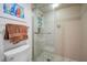 Bathroom featuring a glass shower stall, mosaic tile floor, and fresh towel at 1660 Gulf Blvd # Ph-7, Clearwater Beach, FL 33767