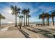Inviting beachfront scene with lush palm trees, soft sand, and a refreshing beach at 1660 Gulf Blvd # Ph-7, Clearwater Beach, FL 33767