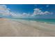 Serene shoreline featuring a sandy beach with tranquil, clear, shallow water at 1660 Gulf Blvd # Ph-7, Clearwater Beach, FL 33767
