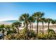 This beach view is lined with palms, white sand and views of the ocean at 1660 Gulf Blvd # Ph-7, Clearwater Beach, FL 33767