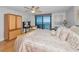 Bedroom featuring a sliding glass door to a balcony and a wooden dresser at 1660 Gulf Blvd # Ph-7, Clearwater Beach, FL 33767