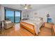 Bright bedroom featuring hardwood floors and a sliding glass door with beautiful water views at 1660 Gulf Blvd # Ph-7, Clearwater Beach, FL 33767
