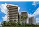 Multi-story condos featuring multiple balconies and lush greenery at 1660 Gulf Blvd # Ph-7, Clearwater Beach, FL 33767