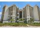 Exterior view of building with multiple balconies and beach access at 1660 Gulf Blvd # Ph-7, Clearwater Beach, FL 33767
