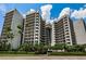 Luxury condo building featuring multiple balconies and a gorgeous front entrance at 1660 Gulf Blvd # Ph-7, Clearwater Beach, FL 33767
