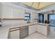 Bright kitchen with white cabinets, light countertops, and a view of the water at 1660 Gulf Blvd # Ph-7, Clearwater Beach, FL 33767