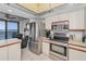 Open kitchen area with stainless steel appliances, white cabinetry, tile flooring and a waterfront view at 1660 Gulf Blvd # Ph-7, Clearwater Beach, FL 33767