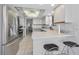 Kitchen featuring stainless steel appliances, white cabinetry, and a bar counter with stool seating at 1660 Gulf Blvd # Ph-7, Clearwater Beach, FL 33767