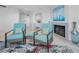 Living room area with bright furniture, a fireplace, decorative accents, and stylish interior design at 1660 Gulf Blvd # Ph-7, Clearwater Beach, FL 33767