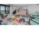 Living room with a colorful rug, comfy seating, and a door leading to the balcony with a view at 1660 Gulf Blvd # Ph-7, Clearwater Beach, FL 33767