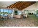 A spacious lounge with beamed ceilings, comfortable seating and floor-to-ceiling windows with stunning beach views at 1660 Gulf Blvd # Ph-7, Clearwater Beach, FL 33767