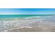 This ocean view features crashing waves on a sandy beach at 1660 Gulf Blvd # Ph-7, Clearwater Beach, FL 33767